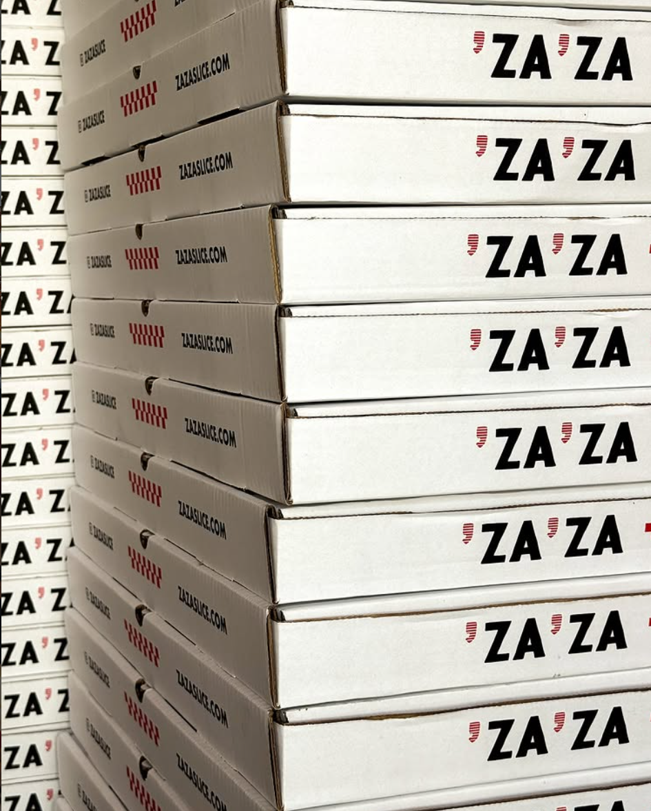 Stacked cream Za Za pizza boxes with red checkerboard print