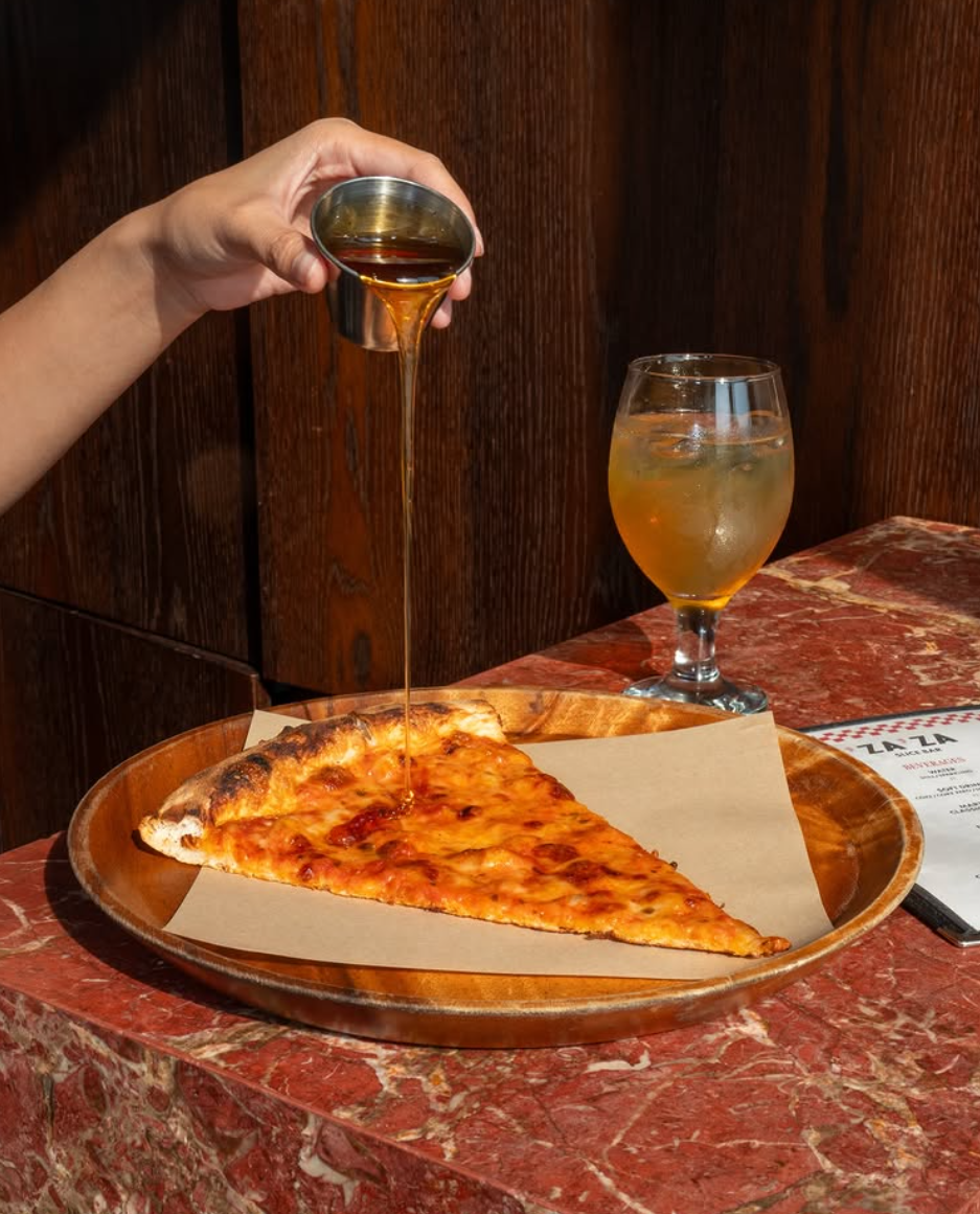 Hot honey poured over a slice on red marble