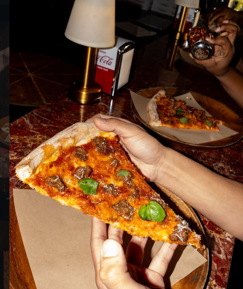Flash photo of a slice held over a red marble table