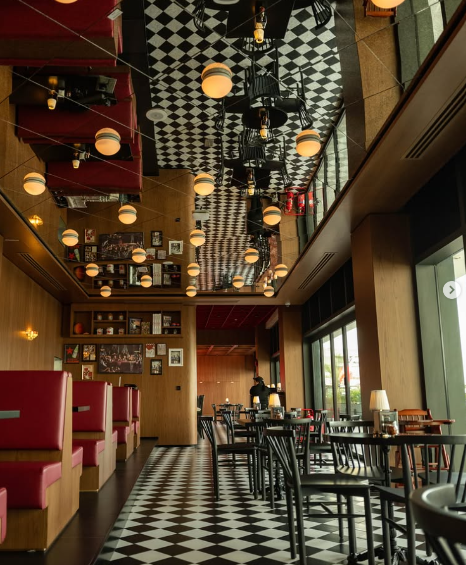 Za Za dining room: checkerboard mirrored ceiling, red booths, pendant lamps