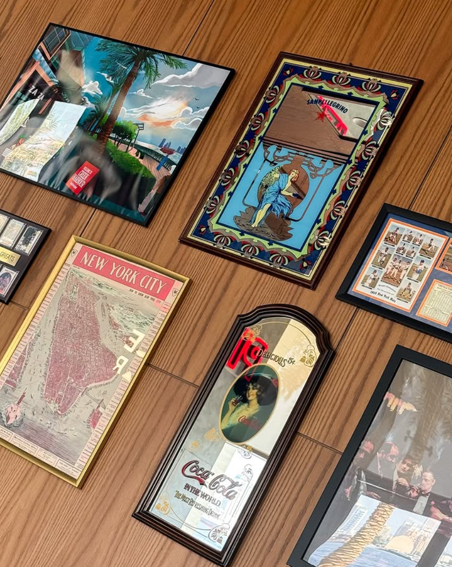 Framed vintage New York and soda advertising on walnut panelling